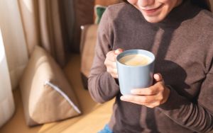 Woman drinking coffee at home