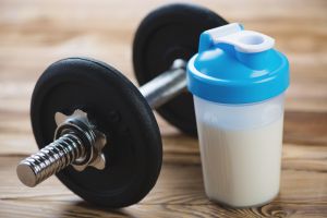 Protein shake and dumbbell