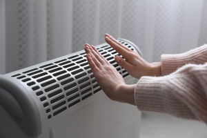 hands over gas heater