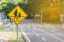 Students crossing ahead sign