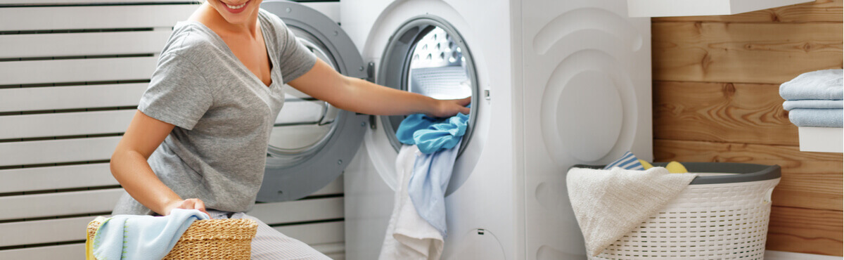 Woman using washing machine