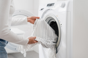 washer dryer with laundry being taken out