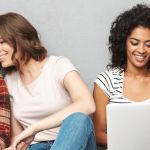 Group of four young people looking at laptop screens