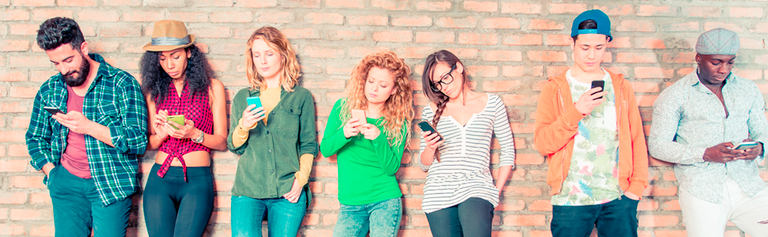 Group of young people looking at their mobile phones