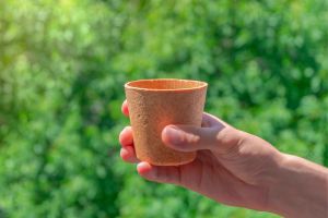 Man holding an edible coffee cup