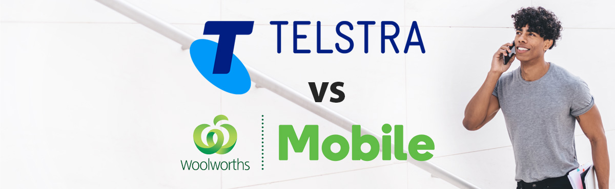 Young man talking on phone carrying books walking up stairs with Telstra and Woolworths Mobile logos