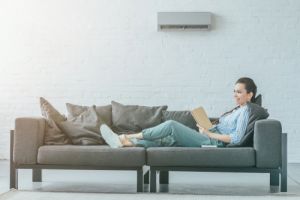 happy woman reading book on couch