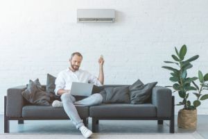man turning on air conditioner