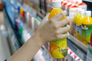 Woman holding a bottle of orange juice