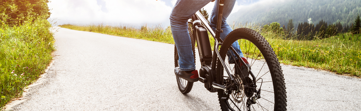 Man Riding Electric Mountain Bike In Alps