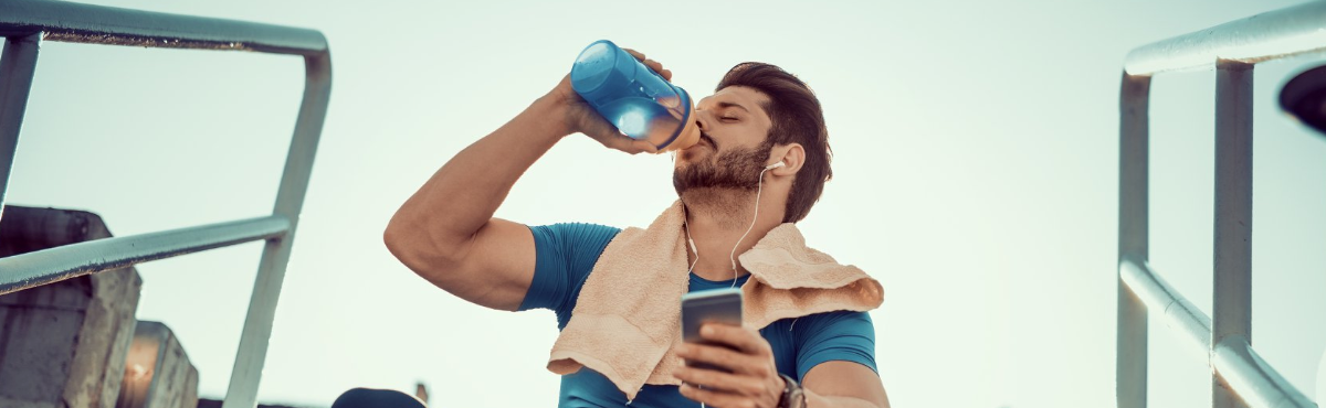 man_drinking_protein_shake_on_steps