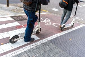 White electric scooters waiting in a bike lane.