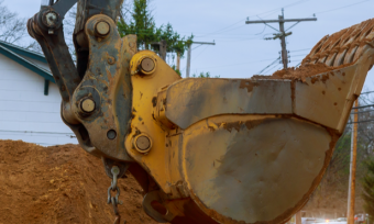 Excavator digging home