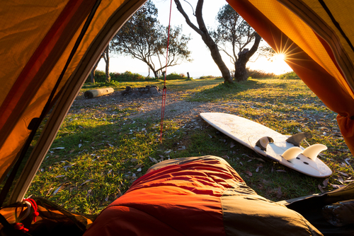 Tent and surfboard near beach