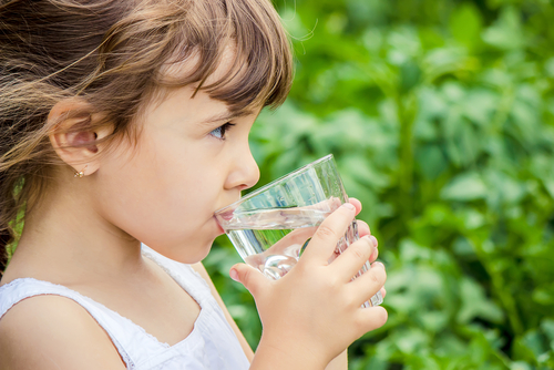 Young girl drinking water