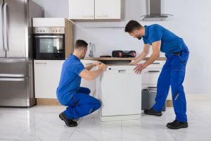 installing dishwasher two men