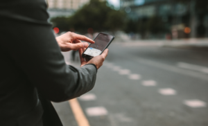 man booking a rideshare on his phone