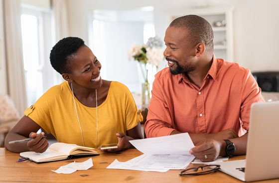 Middle-aged couple comparing bills