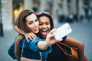 Women taking Snapchat selfie