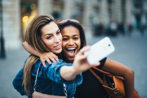 Women taking Snapchat selfie