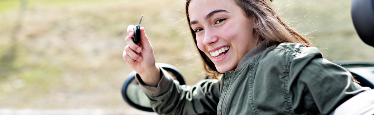 girl holding keys in car