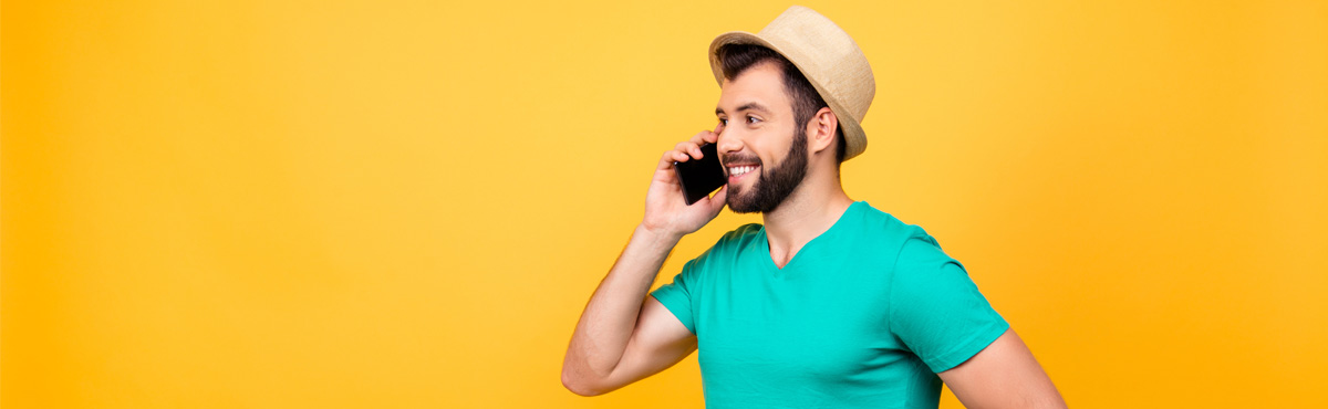 Man talking on phone against yellow background