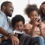 Young family using internet connected devices at home