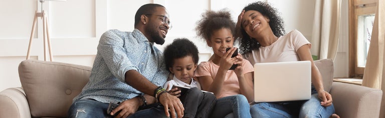 Young family using internet connected devices at home