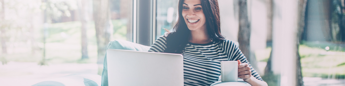 Lady on laptop working from home with coffee