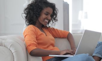 Young woman on couch with laptop