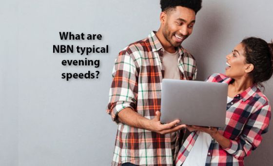 A happy young couple looking at a laptop