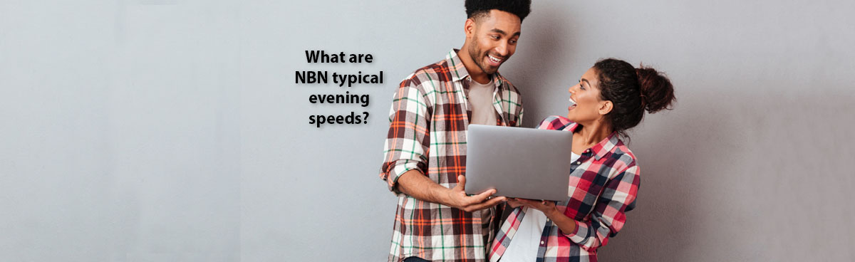 A happy young couple looking at a laptop