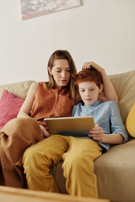 Mother and son using mobile broadband