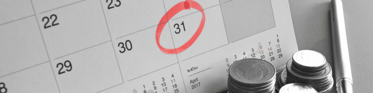 Calendar with date circled for bill payment with coins at forefront