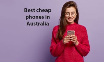 Young woman in red jumper looking at smartphone against purple background