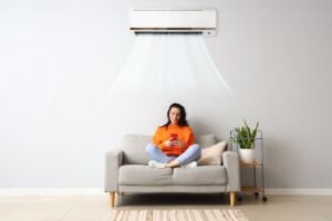 woman sitting on couch with aircon on