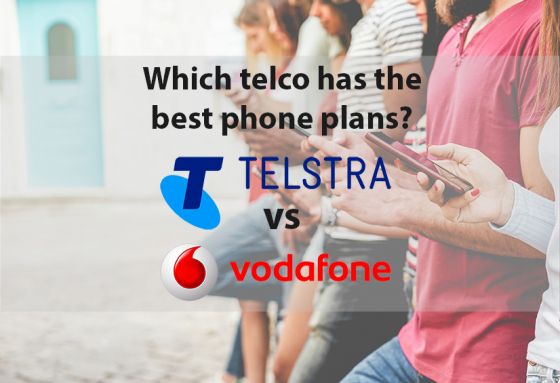 People against wall looking at smartphones with Telstra and Vodafone logos