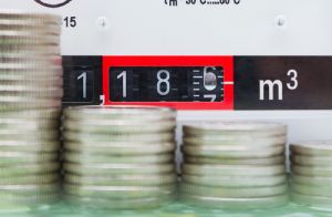 Gas meter with coins in front