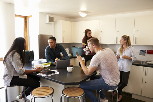 young people sitting around kitchen table