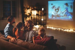 Family watching movie on projector