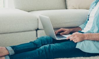 Man using laptop in elegant living room