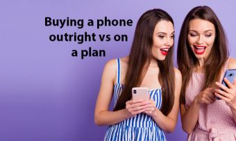 Young women looking at smartphones against purple background