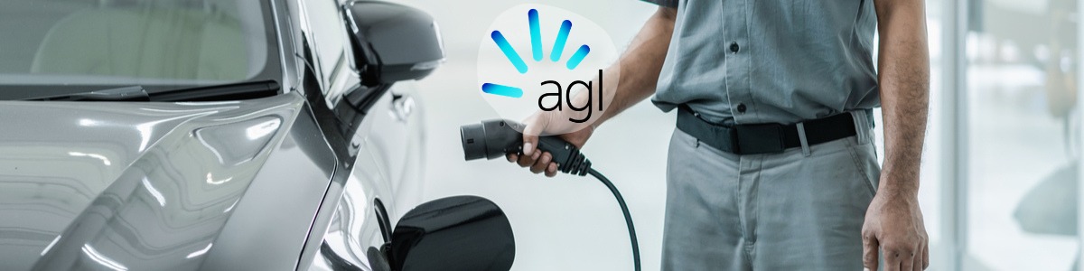 Man charging electric vehicle with AGL logo