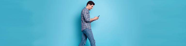 Image for Telstra eSIM activation showing man holding phone against blue background