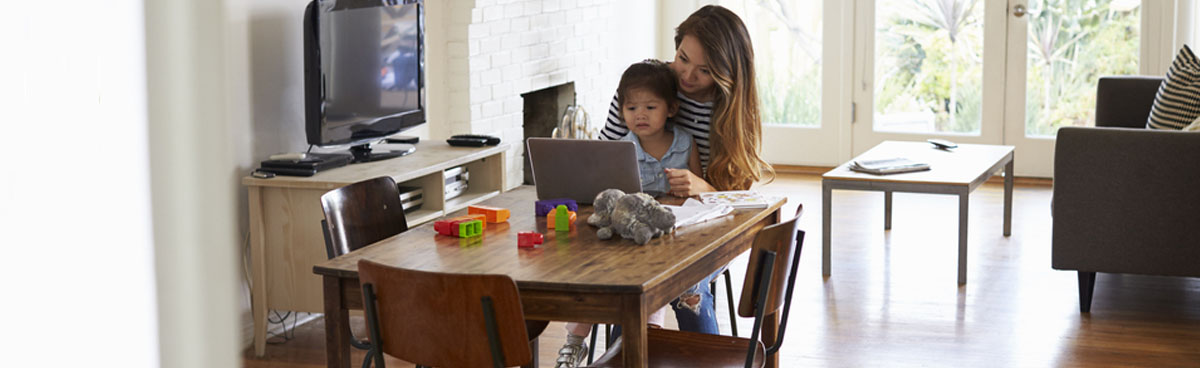 Young mother with child watching using laptop