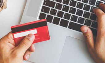 Man online shopping with red credit card