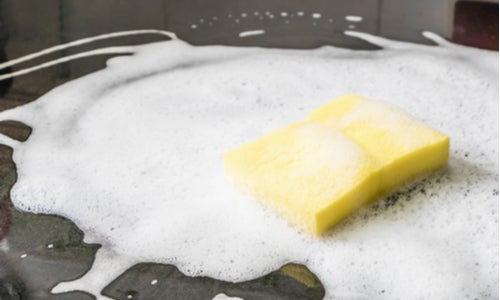 Clean oven with sponge and baking soda