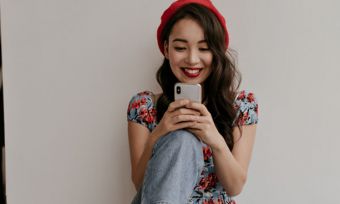 Young woman using smartphone indoors