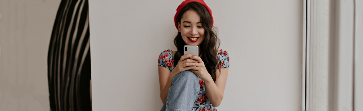 Young woman using smartphone indoors