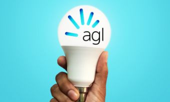 Man holding light bulb with AGL logo on blue background